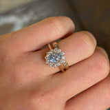 Blue sapphire and diamond cluster engagement ring