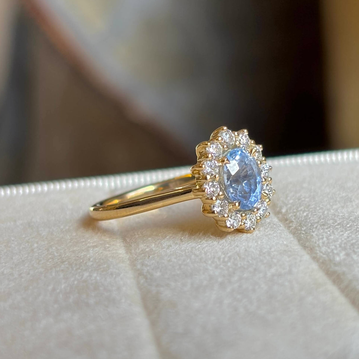 Blue sapphire and diamond cluster engagement ring