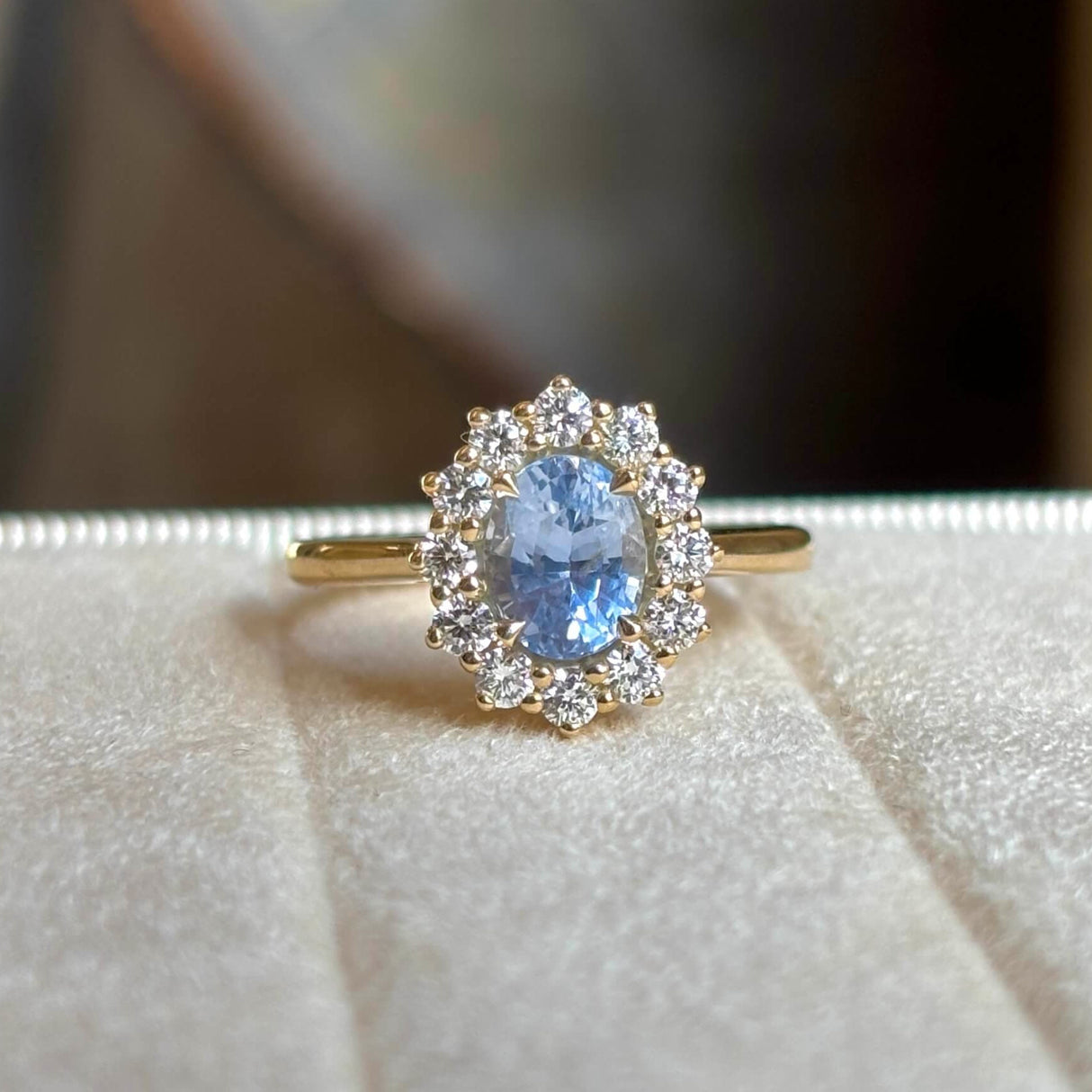 Blue sapphire and diamond cluster engagement ring