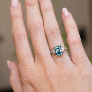 An antique Art Deco 1920s zircon and diamond ring worn on the hand.