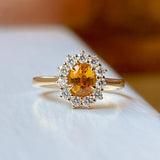 Oval-cut orange sapphire & diamond cluster engagement ring