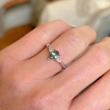 Pear-cut teal sapphire & diamond three-stone engagement ring