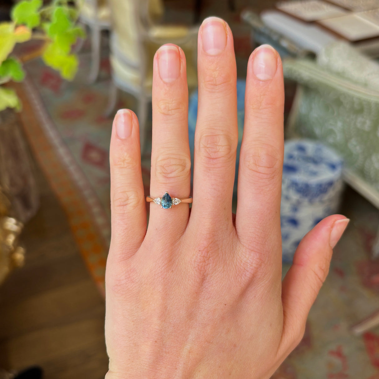 Pear-cut teal sapphire & diamond three-stone ring