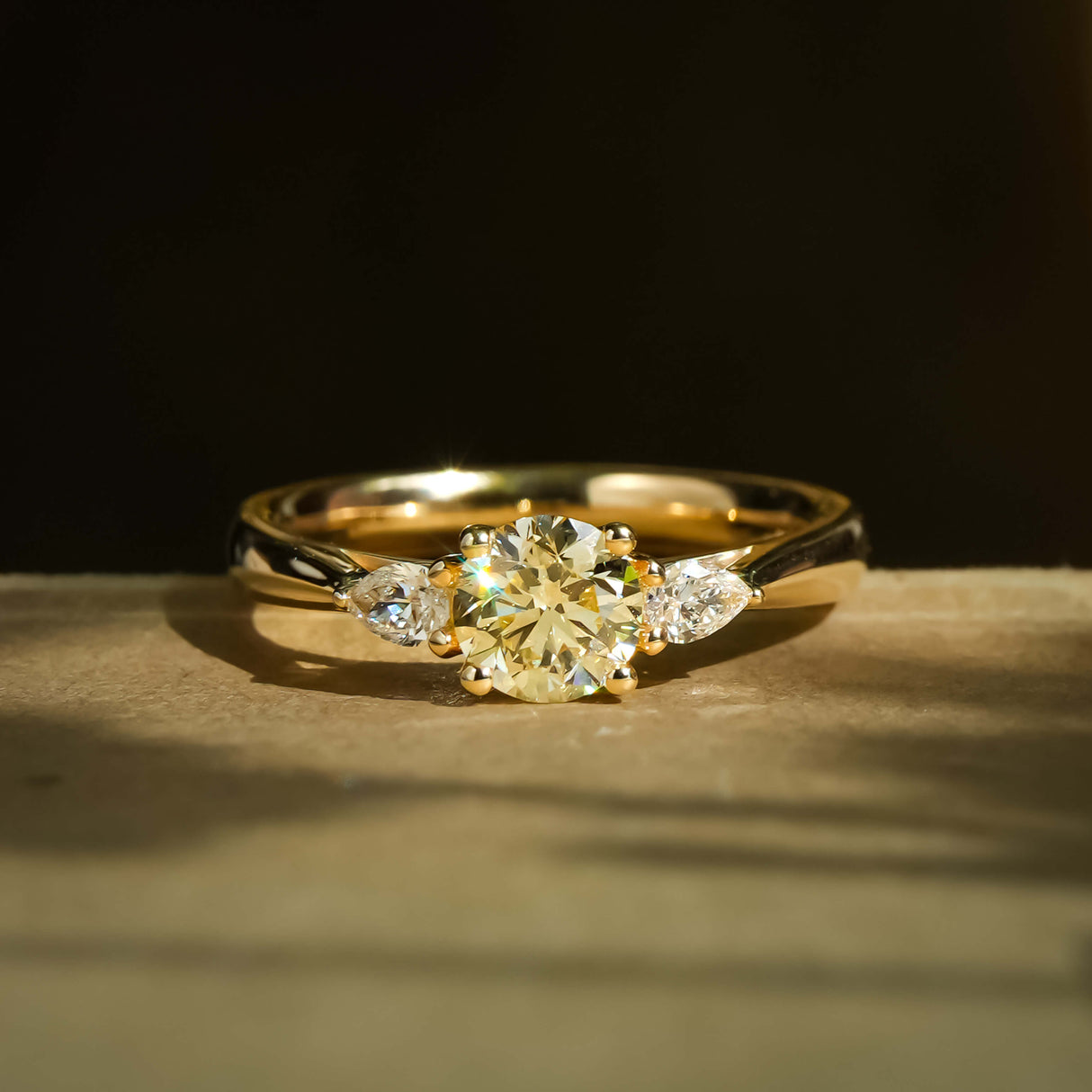 Round champagne diamond with white diamond three stone engagement ring in yellow gold