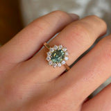 Green sapphire and diamond cluster engagement ring