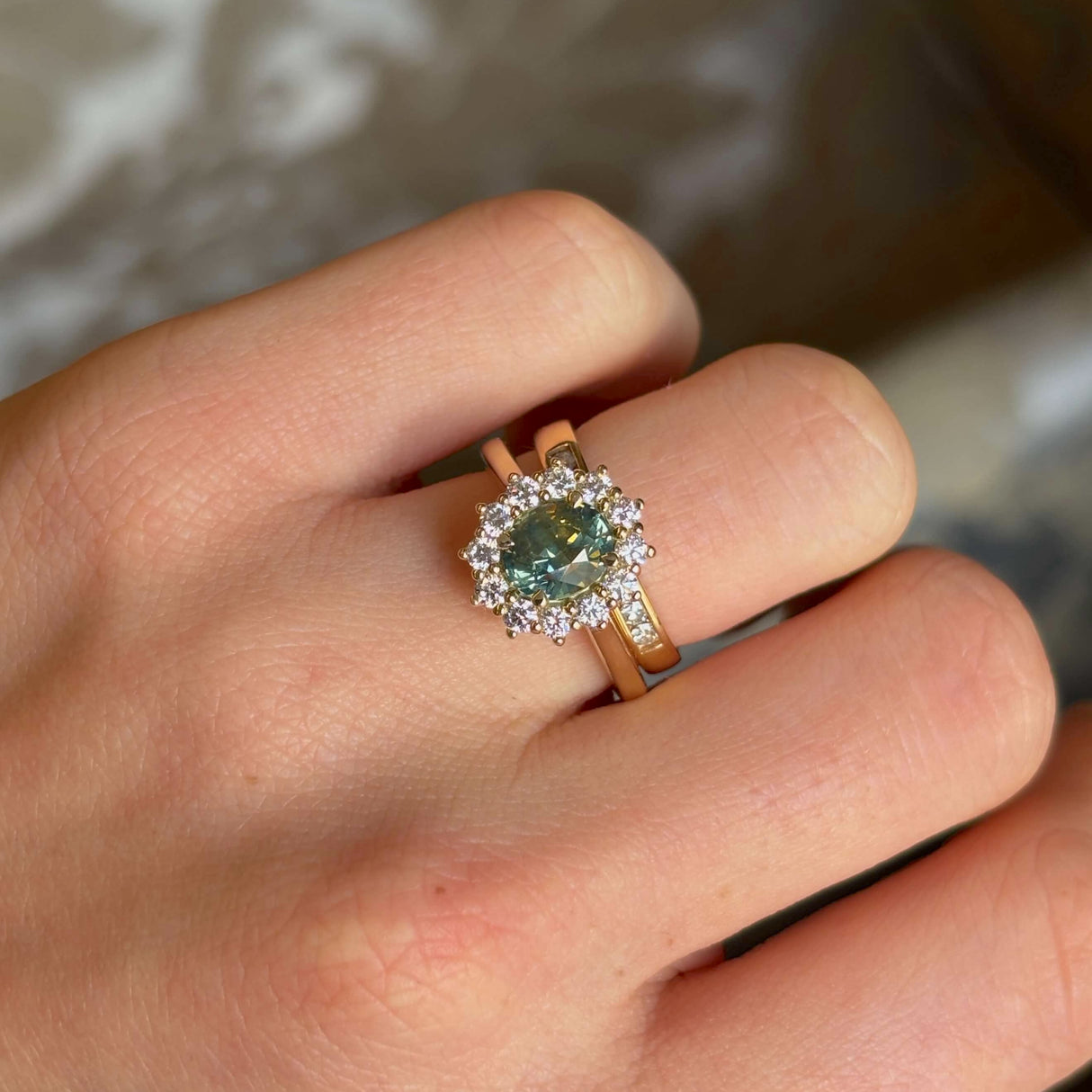 Green sapphire and diamond cluster engagement ring