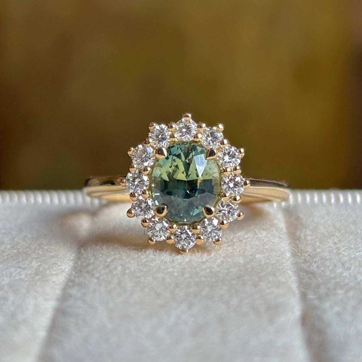 Green sapphire and diamond cluster engagement ring