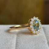 Green sapphire and diamond cluster engagement ring