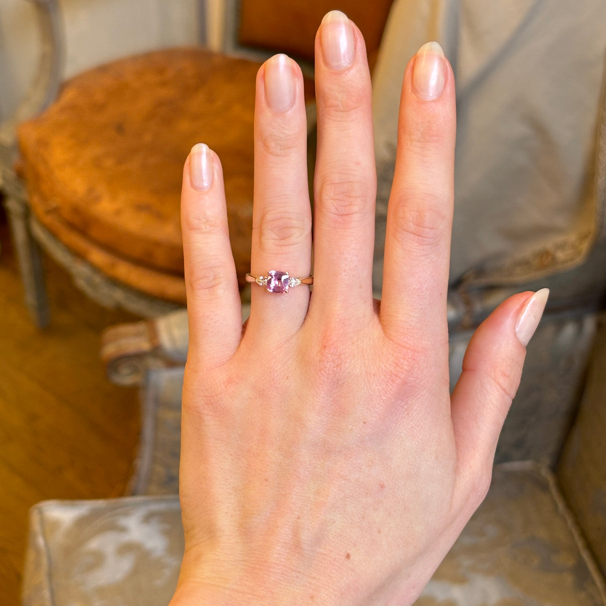 Pink sapphire and diamond three-stone engagement ring