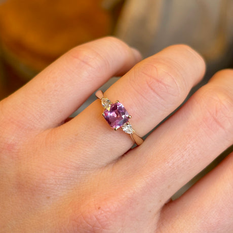 Pink sapphire and diamond three-stone engagement ring