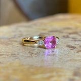 Pink sapphire and diamond three-stone engagement ring