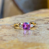 Pink sapphire and diamond three-stone engagement ring