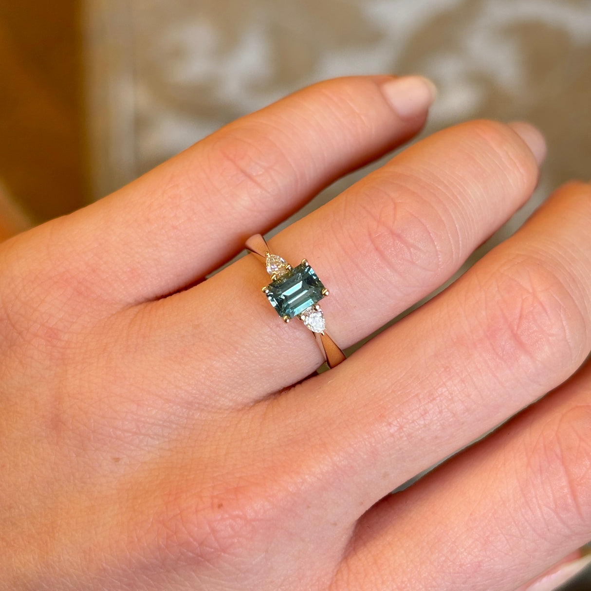 Green sapphire and diamond three-stone engagement ring