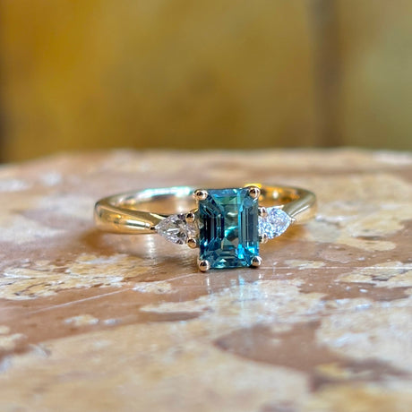 Green sapphire and diamond three-stone engagement ring