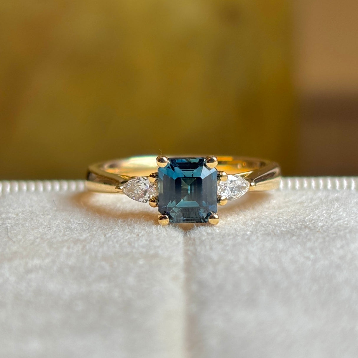 Teal sapphire and diamond three-stone engagement ring