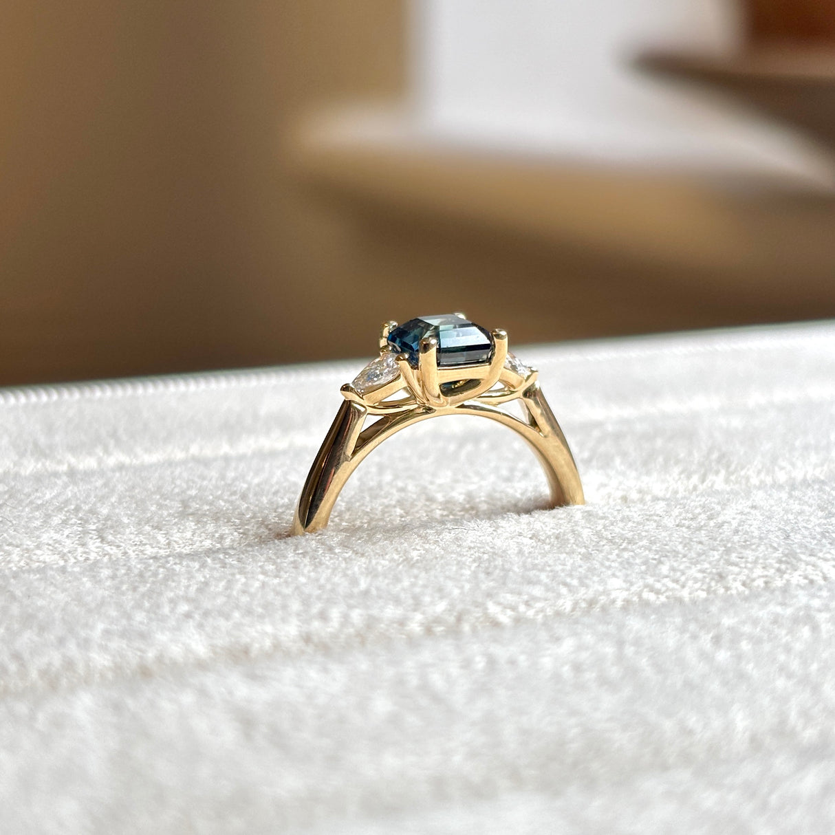 Teal sapphire and diamond three-stone engagement ring