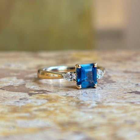 Teal sapphire and diamond three-stone engagement ring