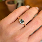 Green sapphire and diamond three-stone engagement ring