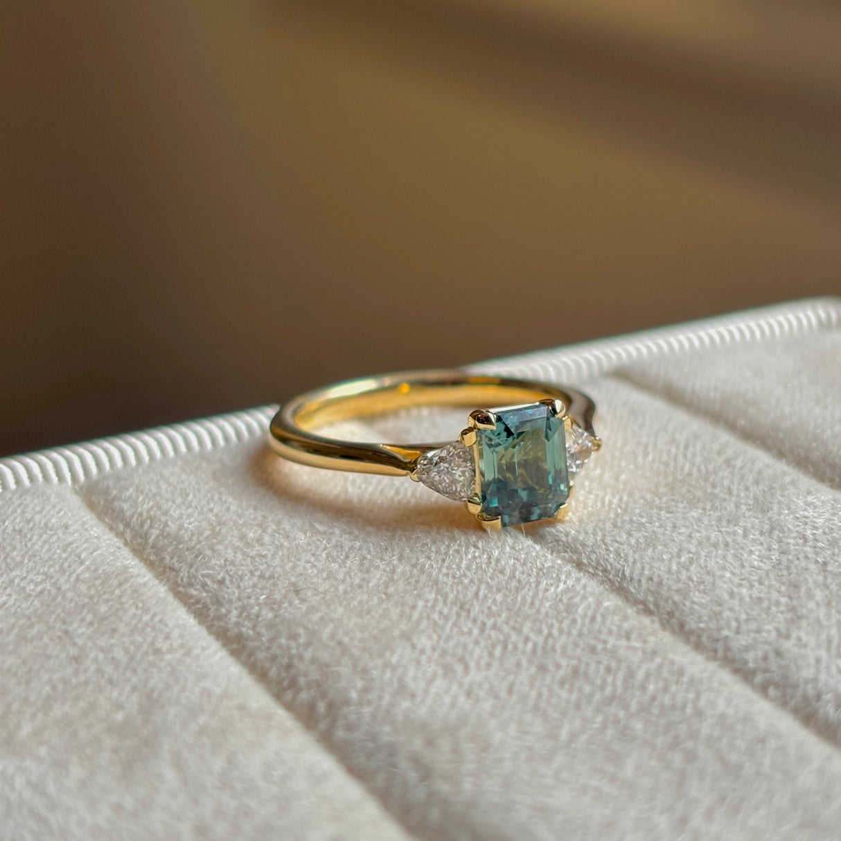 Green sapphire and diamond three-stone engagement ring