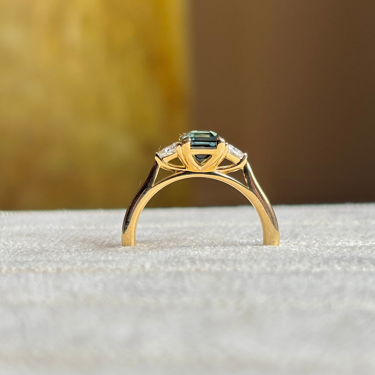 Green sapphire and diamond three-stone engagement ring