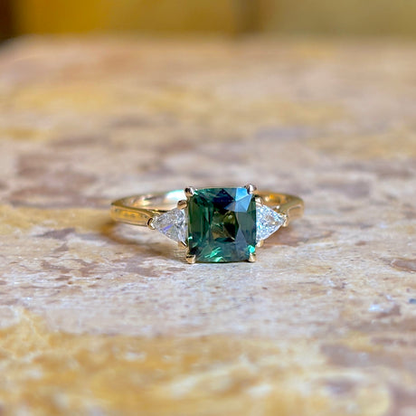 Teal sapphire and diamond three-stone engagement ring