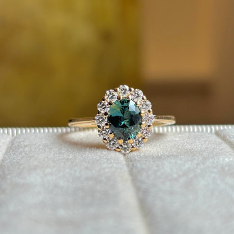 Green sapphire and diamond cluster engagement ring