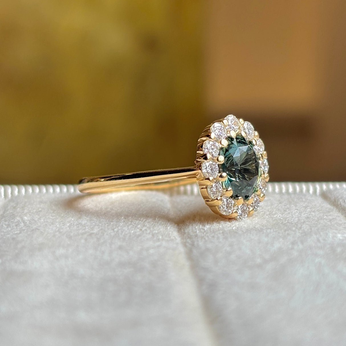 Green sapphire and diamond cluster engagement ring