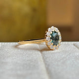 Green sapphire and diamond cluster engagement ring
