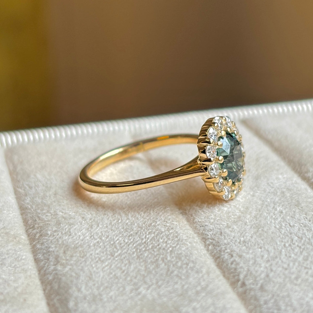 Green sapphire and diamond cluster engagement ring