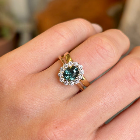 Green sapphire and diamond cluster engagement ring