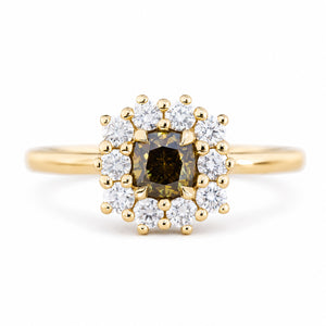 A close-up of an antique-inspired, Brown diamond halo cluster engagement ring in yellow gold.