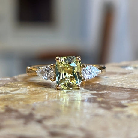Emerald-cut yellow sapphire and diamond three-stone ring