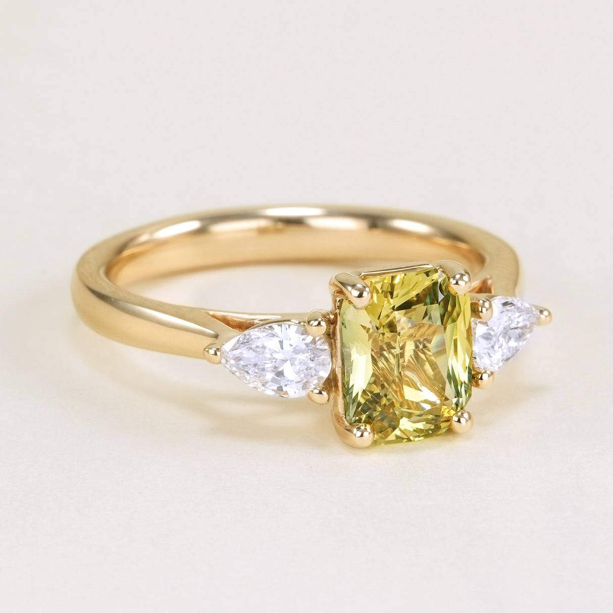 Emerald-cut yellow sapphire and diamond three-stone ring