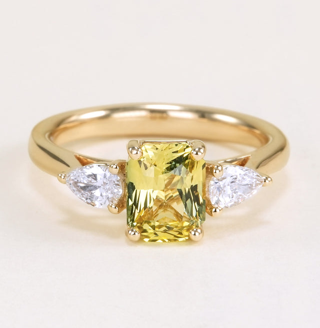 Emerald-cut yellow sapphire and diamond three-stone ring