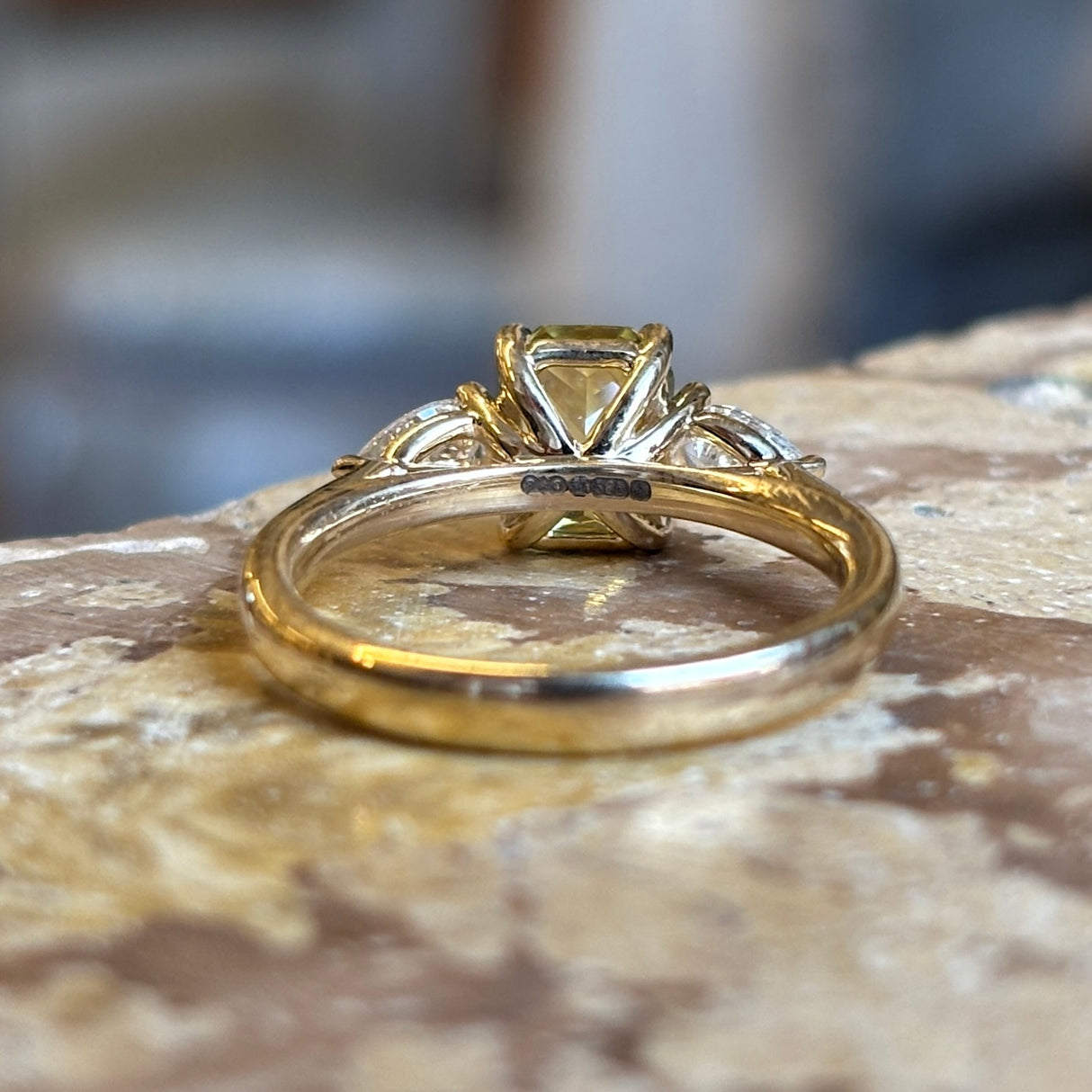 Emerald-cut yellow sapphire and diamond three-stone ring