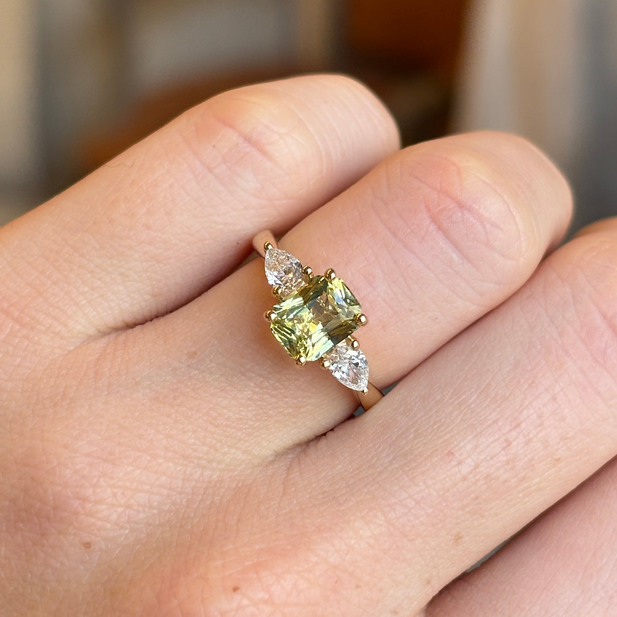 Emerald-cut yellow sapphire and diamond three-stone ring