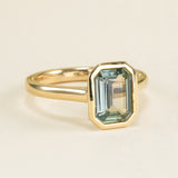 Emerald-cut teal sapphire single-stone ring