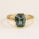 Emerald-cut teal sapphire single-stone ring
