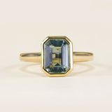 Emerald-cut teal sapphire single-stone ring