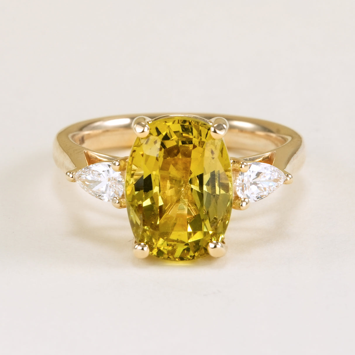 Chrysoberyl and pear-cut diamond three-stone ring