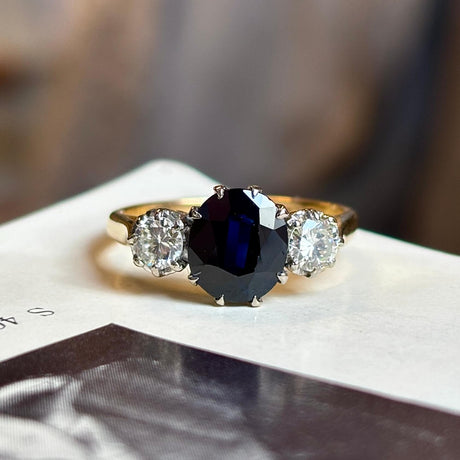 Vintage, 1950s dark blue sapphire and diamond three-stone engagement ring