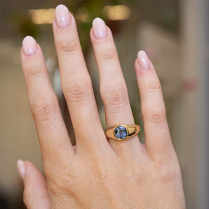 An antique Victorian colour-change sapphire gypsy ring worn on the hand.