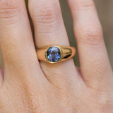 An antique Victorian colour-change  blue sapphire gypsy ring worn on the finger.