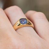Close-up of an antique Victorian colour-change blue-purple sapphire gypsy ring in yellow gold.