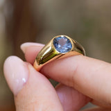 A close-up of an antique Victorian colour-change sapphire gypsy ring in yellow gold highlighting the bezel-setting.