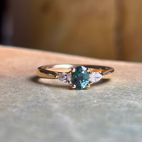 Teal sapphire and diamond three-stone engagement ring