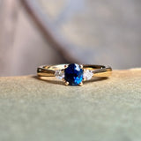 Blue sapphire and diamond three-stone engagement ring