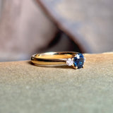 Blue sapphire and diamond three-stone engagement ring