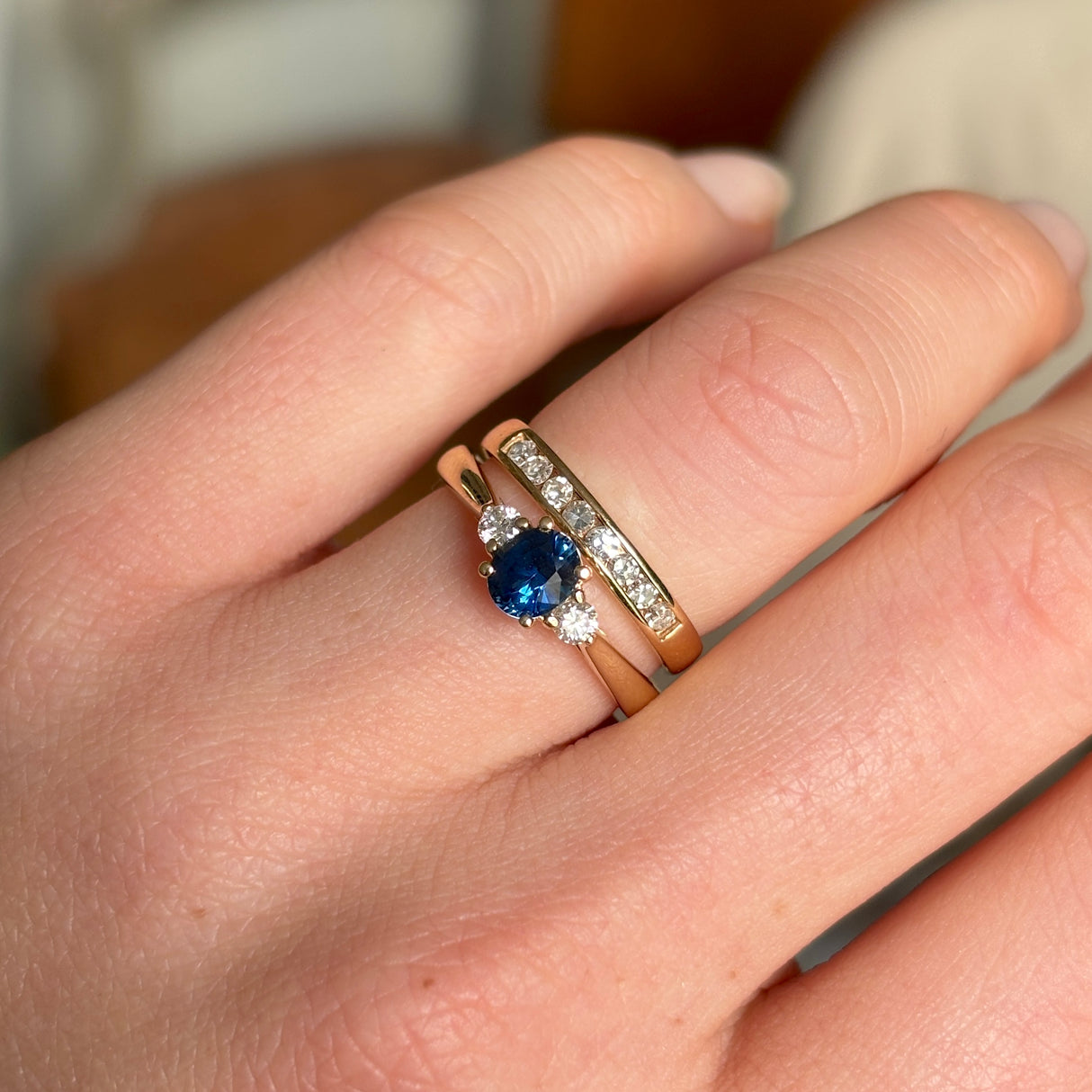 Blue sapphire and diamond three-stone engagement ring