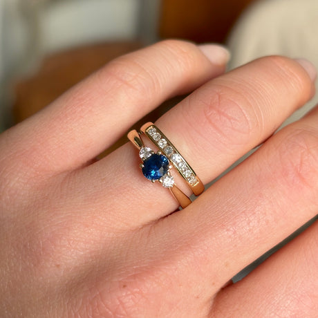 Blue sapphire and diamond three-stone engagement ring